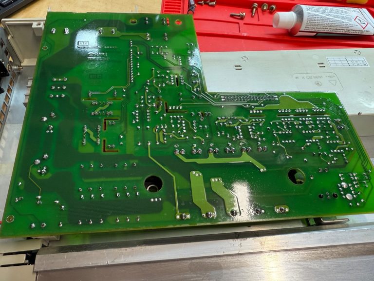 LT module repaired and conformally coated Green printed circuit board with various components and connections.